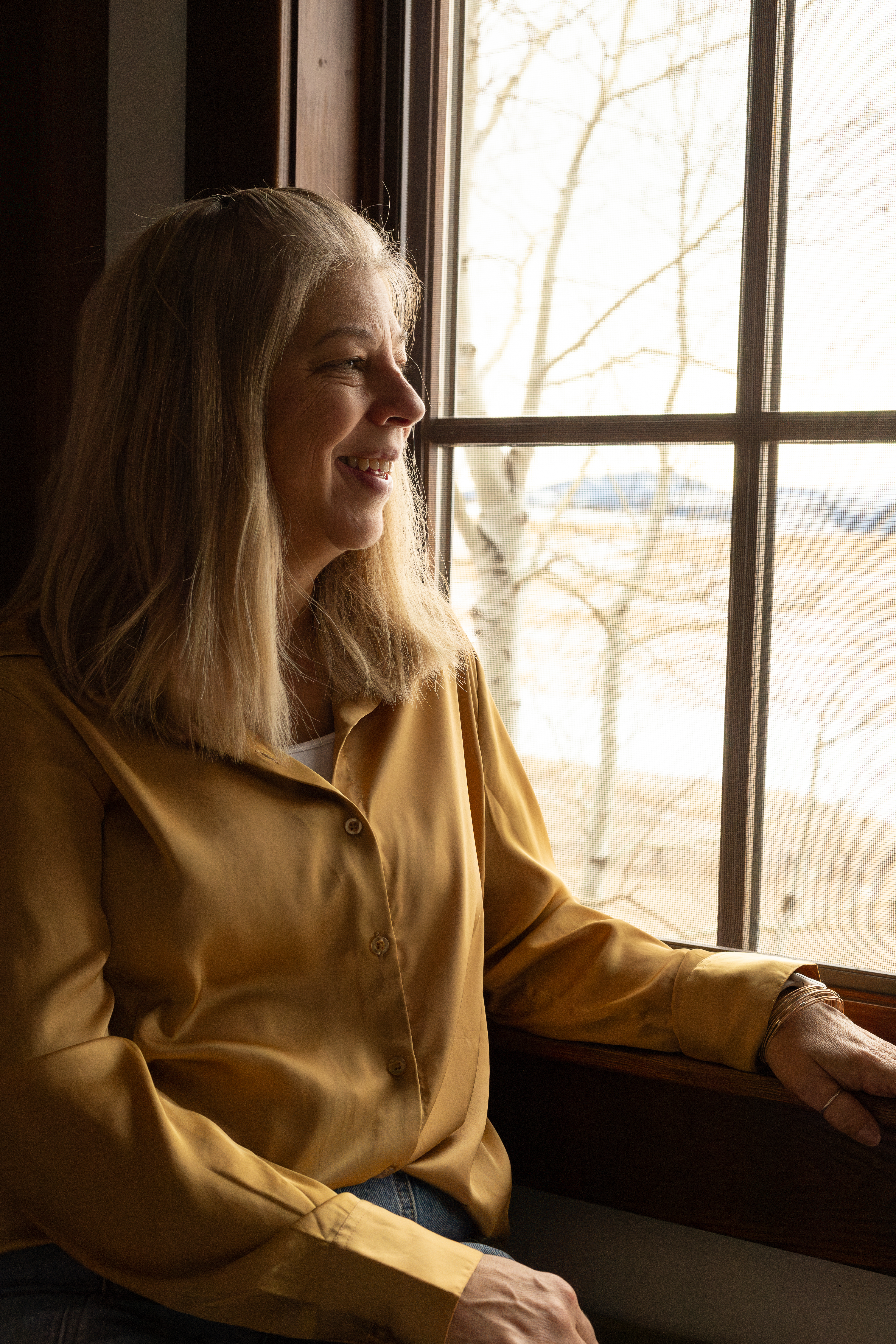 Tricia sitting at window